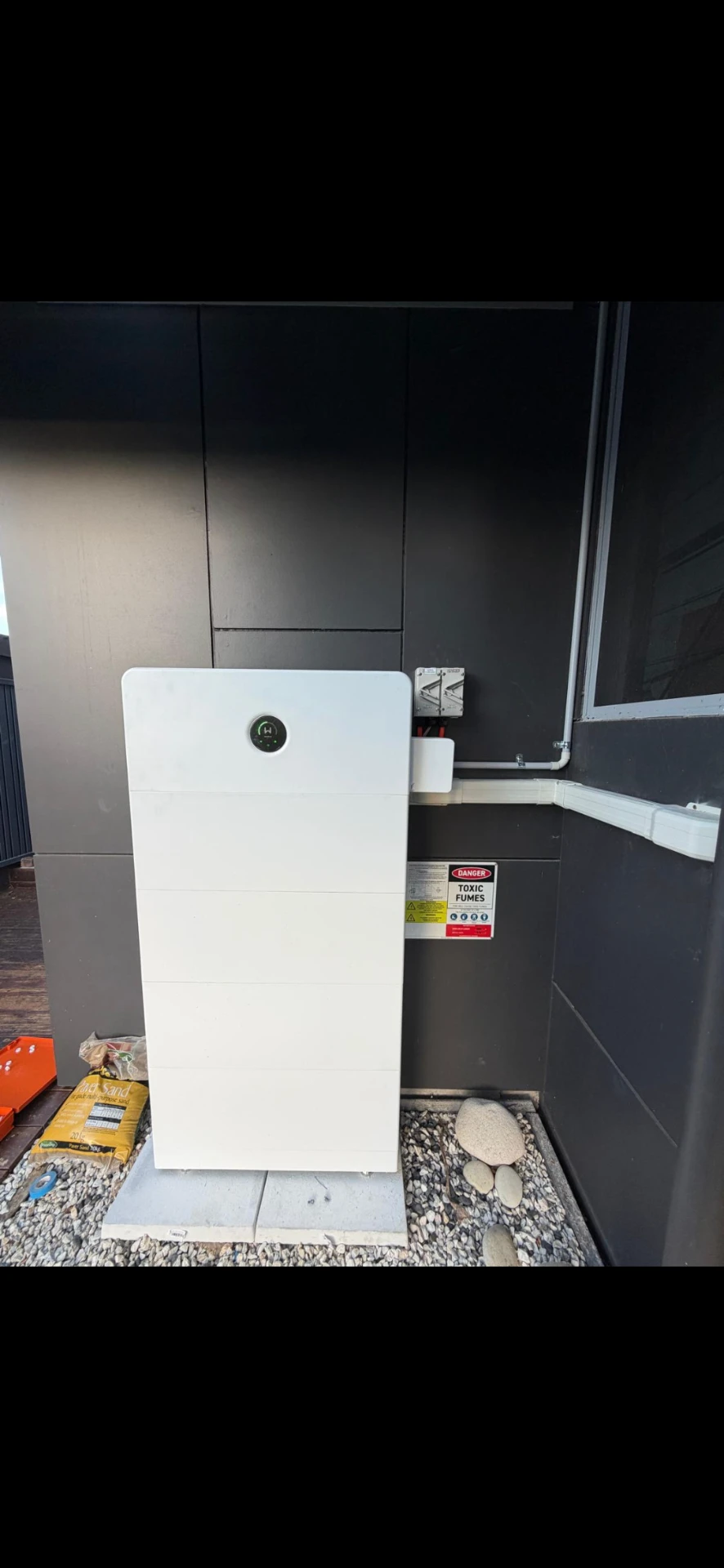 Battery storage system mounted on an exterior wall